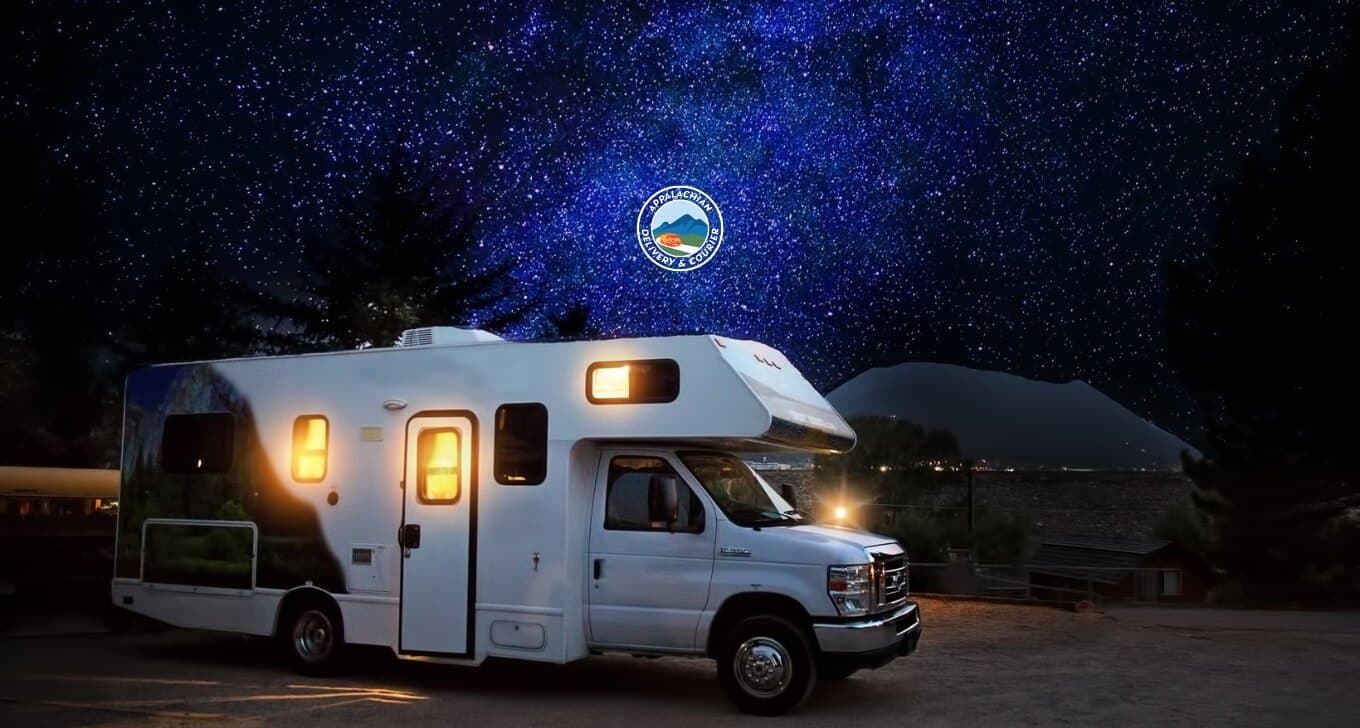 A cozy RV at a campground under a starry night sky